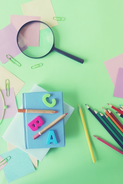 Books and stationery on bright background top view flat ley back to school concept education