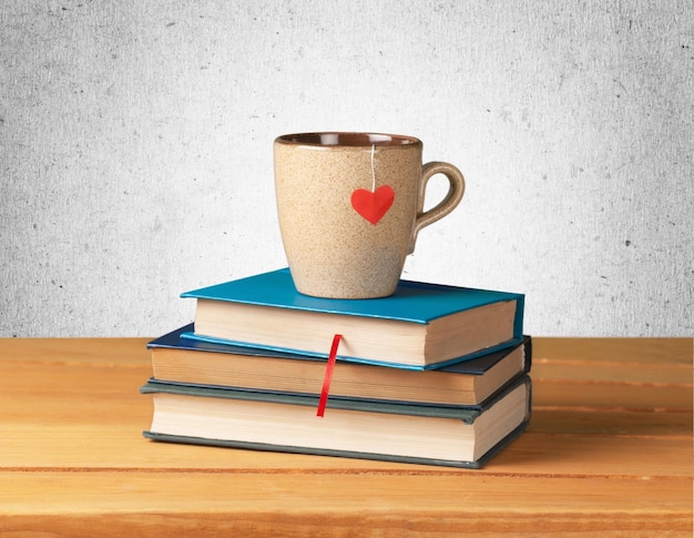 Books, tea cup with heart on table