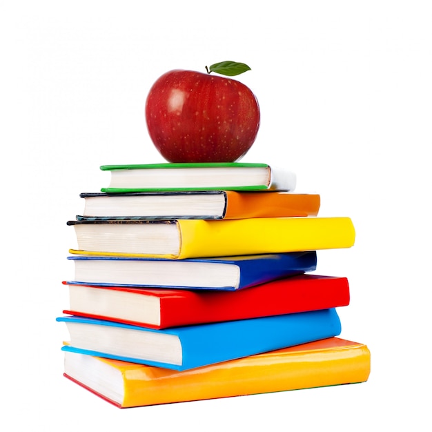 Books tower with apple isolated on white