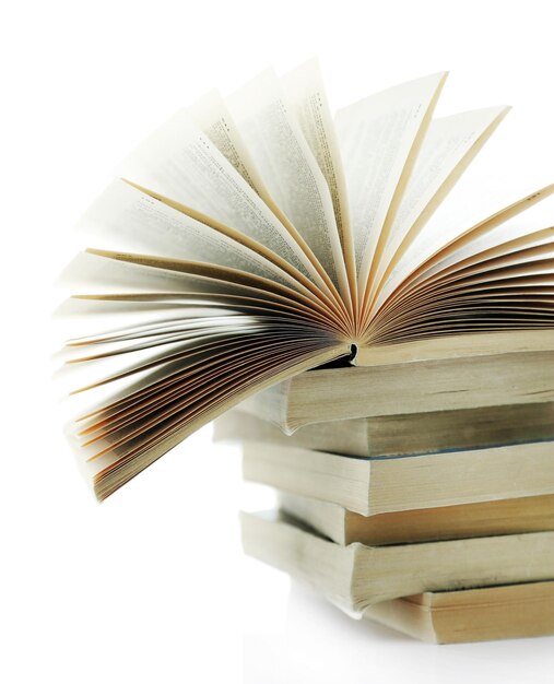 Books on white windowsill close up