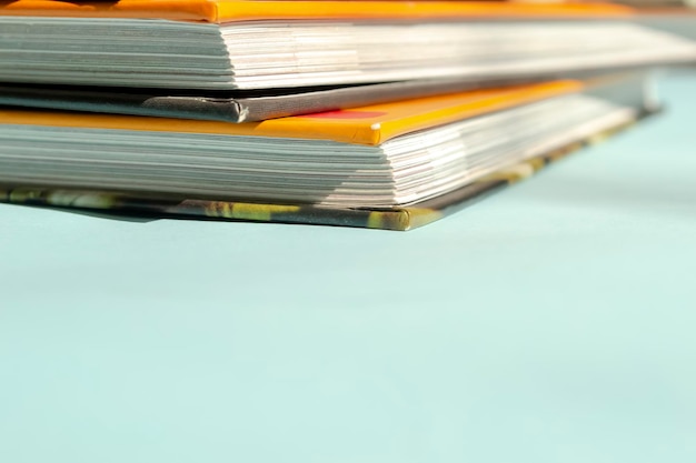 Books with a bright orange cover On a blue background lies a stack of books