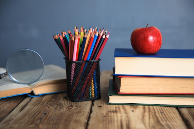 Books with pencils on table