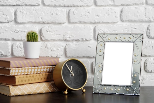 Books with picture frame on wooden table