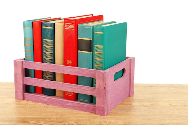 Books in wooden box isolated on white