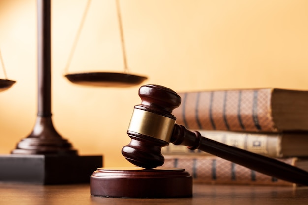 Books and wooden gavel on table. Justice concept