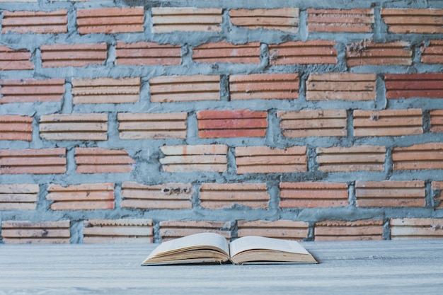 Photo books on wooden ladder on color wall background