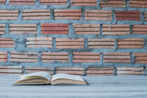 Photo books on wooden ladder on color wall background