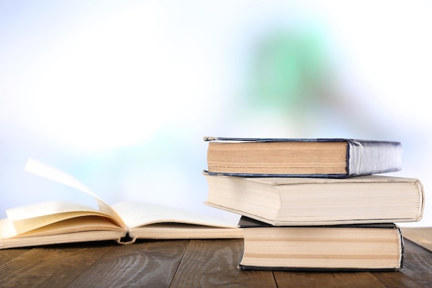 Books on wooden table on natural background