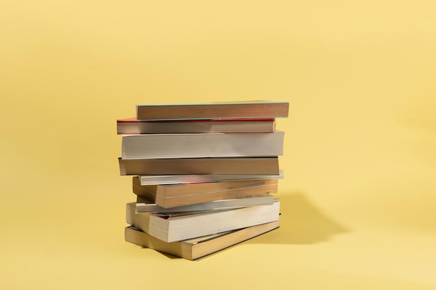 Books on yellow background creative concept ideas