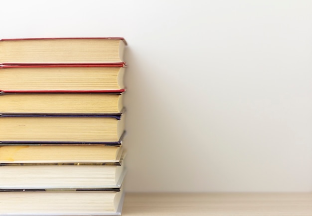 BooksA stack of neatly stacked books on a table or shelf with a copy of the space