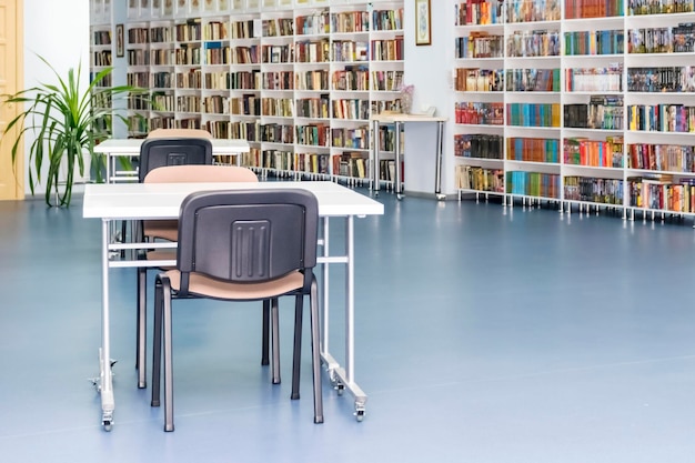 Photo bookshelves in the library with tables and chairs