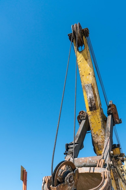 Photo boom and other parts of the quarry excavator closeup work on the territory of a mining enterprise for the extraction of sand gravel and coal