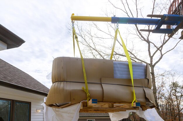 Boom truck crane with scale weight above blue sky in modern jacuzzi