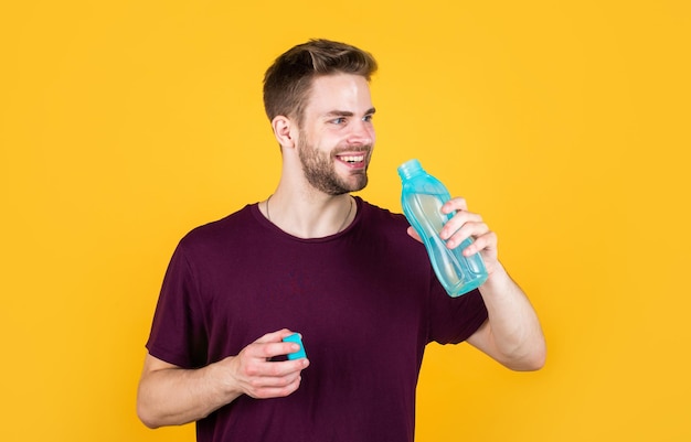 Boost energy Thirsty fitness male enjoying refreshing drink concept of drinking water benefits man drinking water Drinking water Handsome Young Man With Fit Body Drinking Fresh Water