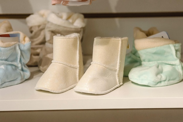 Booties for a newborn in a children's store Concept of preparation for the birth of a child