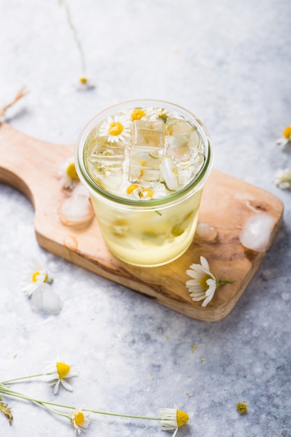 Boozy long iced tea with chamomile flowers