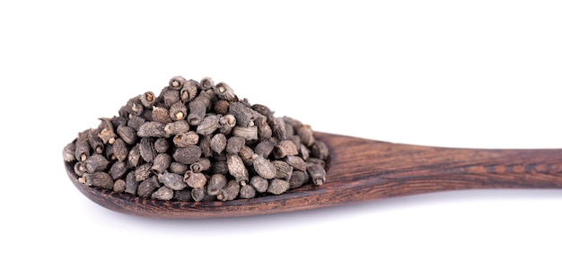 Borage seeds in wooden spoon isolated on a white background Borago officinalis seeds