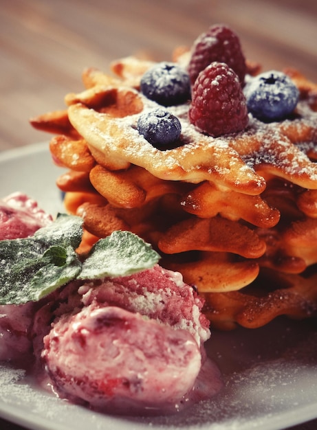 Bord belgische wafels met roomijs en verse bessen frambozen en bosbessen