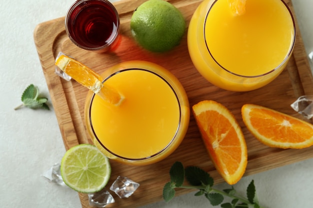 Bord met Tequila Sunrise-cocktails op witte getextureerde tafel