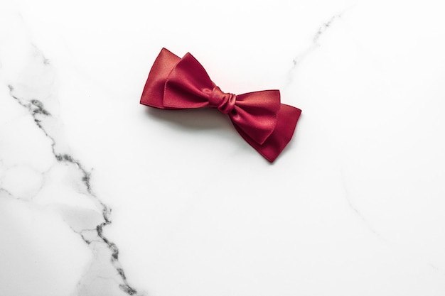 Bordeaux silk ribbon on marble background flatlay