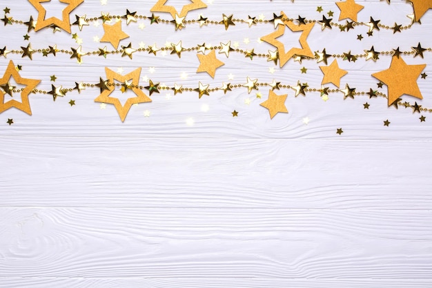 Border of big and small stars of confetti Golden beads in the form of stars