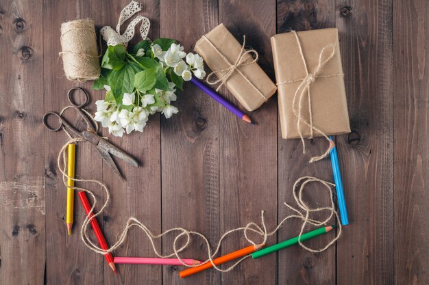 Photo border of colored pencils and white flower