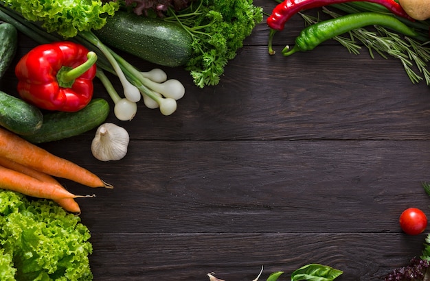 Border of fresh vegetables on wood with copy space