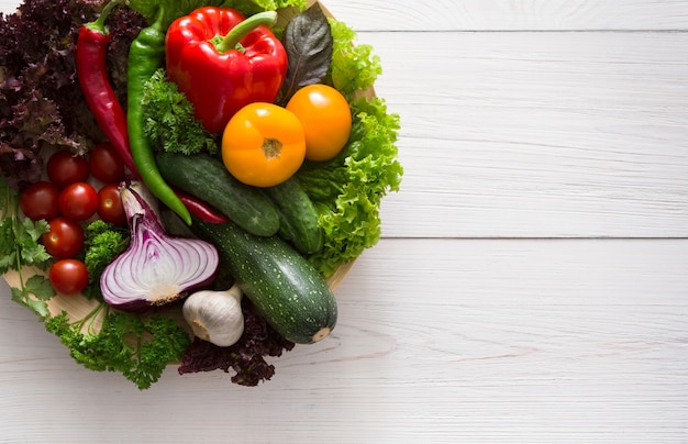 Border of fresh vegetables on wood with copy space