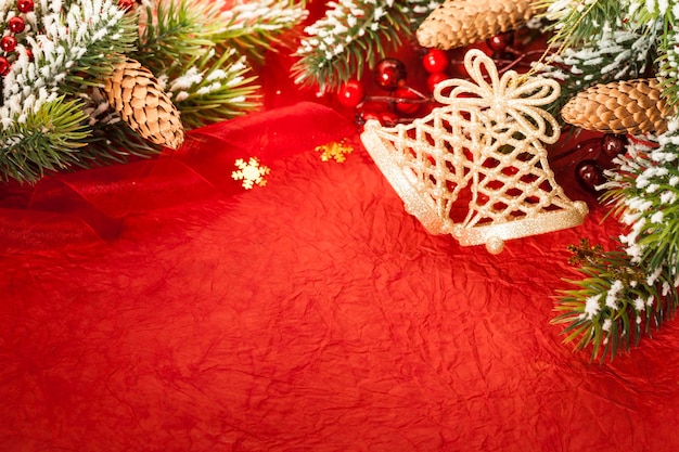 Border from Christmas tree decoration on red paper