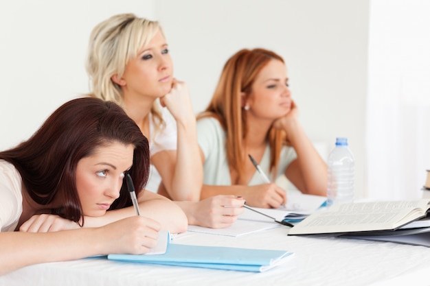 Bored-to-death students sitting at a table