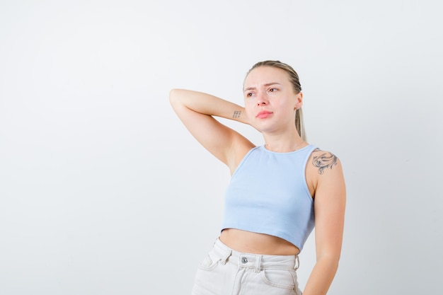 Photo bored girl is thinking something on white background