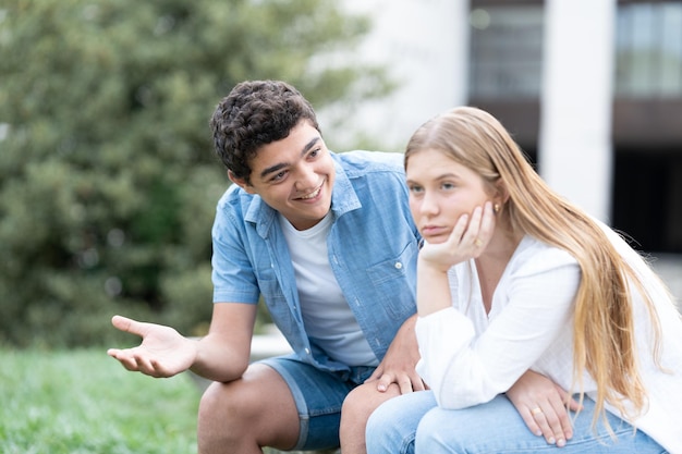 Bored girl listening and ignoring boyfriend