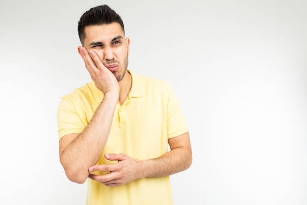 Bored man on a white studio background with copy space.