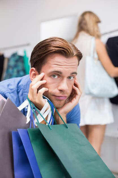 A bored man with his hands under his chin