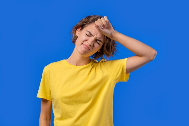 Bored upset woman on blue background pretty lady in displeasure she is tired of situation empty promises talks high quality photo person