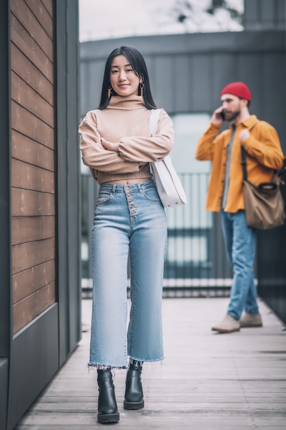 Bored woman. Young woman feeling bored while her boyfriedns talking on the phone