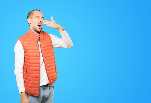 Bored young man yawning gesture