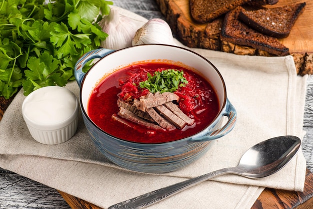 Borscht soup borscht with meat on a wooden white background