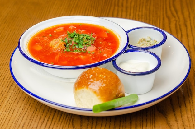 borscht with donut and sour cream