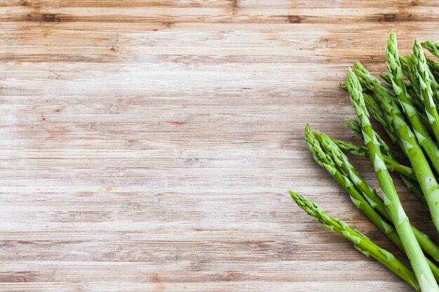 Bos van groene asperge op houten raad met exemplaarruimte