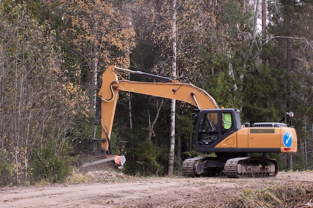 Bosbouwgraafmachine-mulcher die langs de weg ruimt met mulchmachine