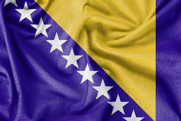 写真 ボスニア・ヘルツェゴビナの国旗の背景のリアルなシルク生地
