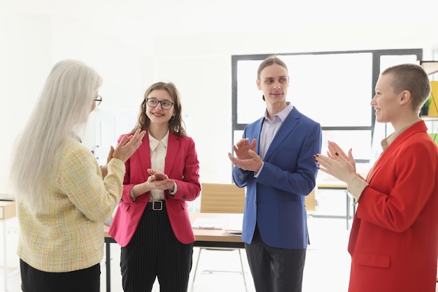 Boss and employees applaud to greet worker achievement in company premise positive relationship