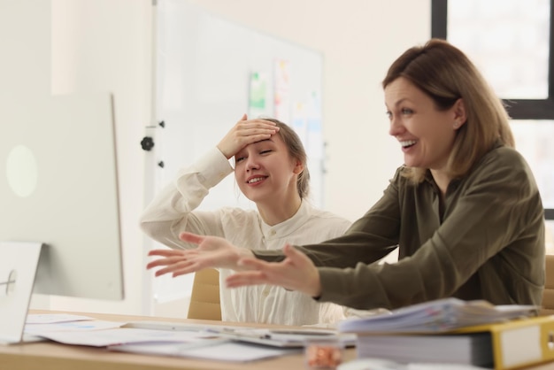 Boss explains error of employee in office closeup young manager understands her mistake while