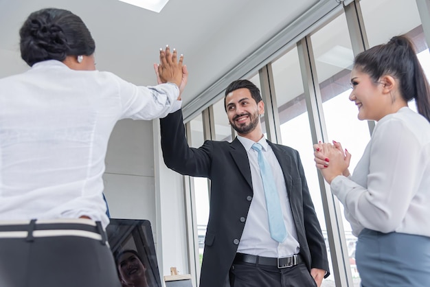 Boss hand together with businesswoman for unityteamwork in modern office