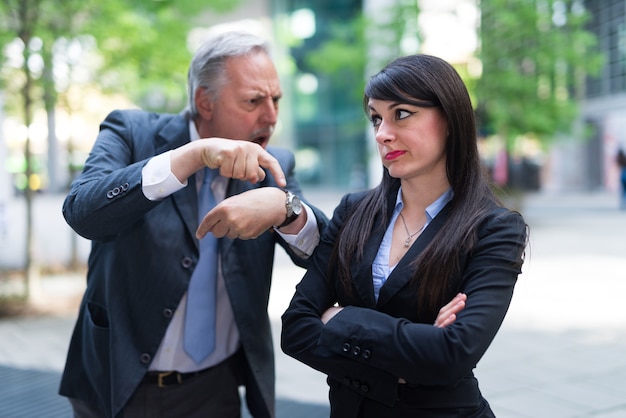 Boss scolding an employee for being late