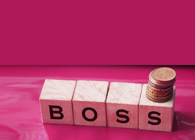 The boss sign on a wooden cubes on black Business owner concept