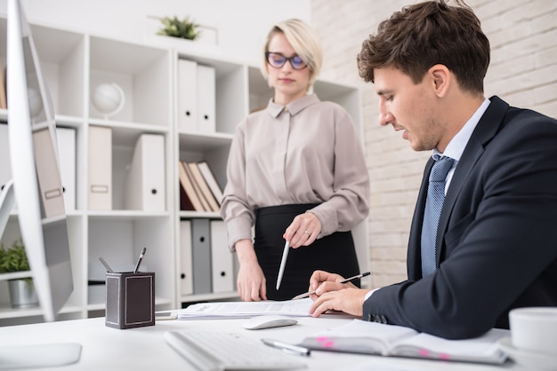 Boss Signing Documents at Desk