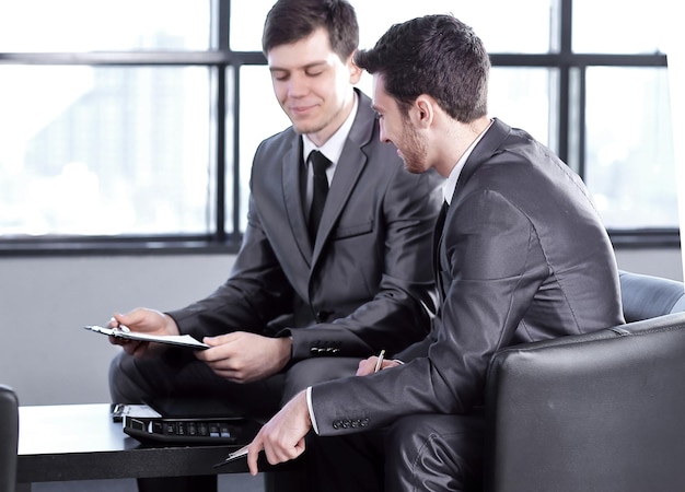 Boss with a clipboard sitting in an office photo with copy space