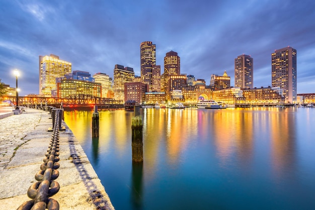 Boston Massachusetts USA downtown city skyline from the harbor at dusk